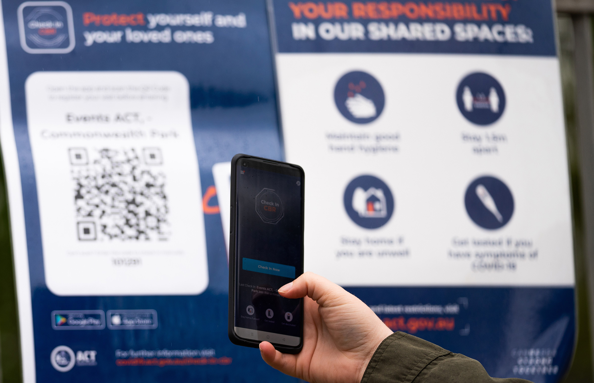 Person using COVID check in app Person using COVID check in app