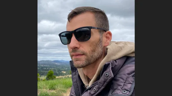 A man wearing sun glasses looking away from the camera