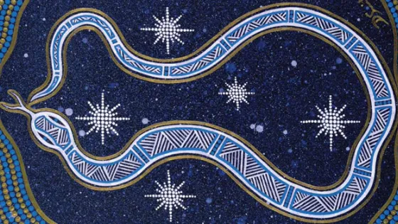 A decorative Aboriginal art piece depicting a snake-like pattern intertwined with dotted stars against a dark blue background.