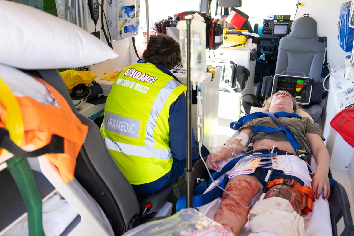 Scene inside an ambulance with a patient and fake blood