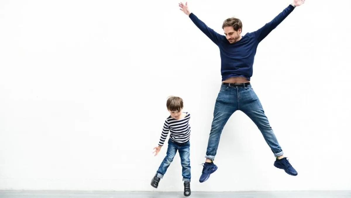 Man and child jumping around healthily