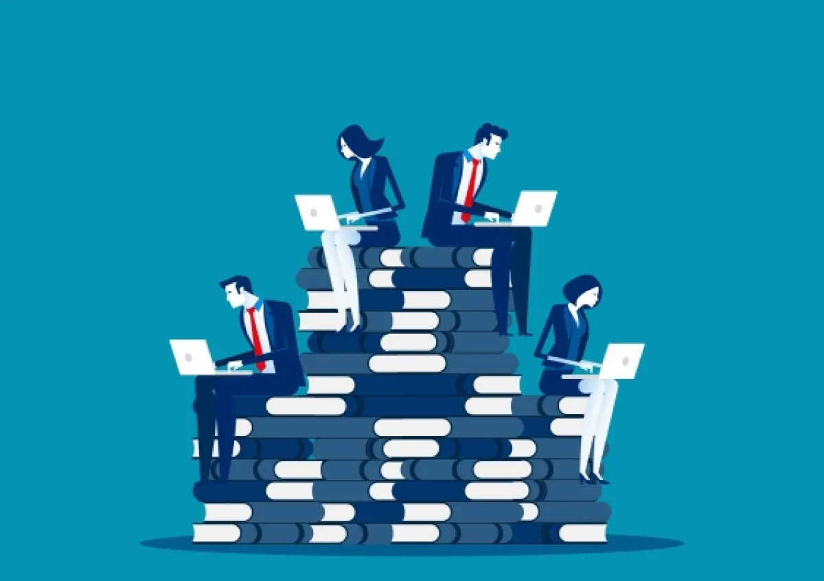 Illustration of five business professionals using laptops while sitting on a stacked pile of large books, symbolizing a hierarchy or progression.