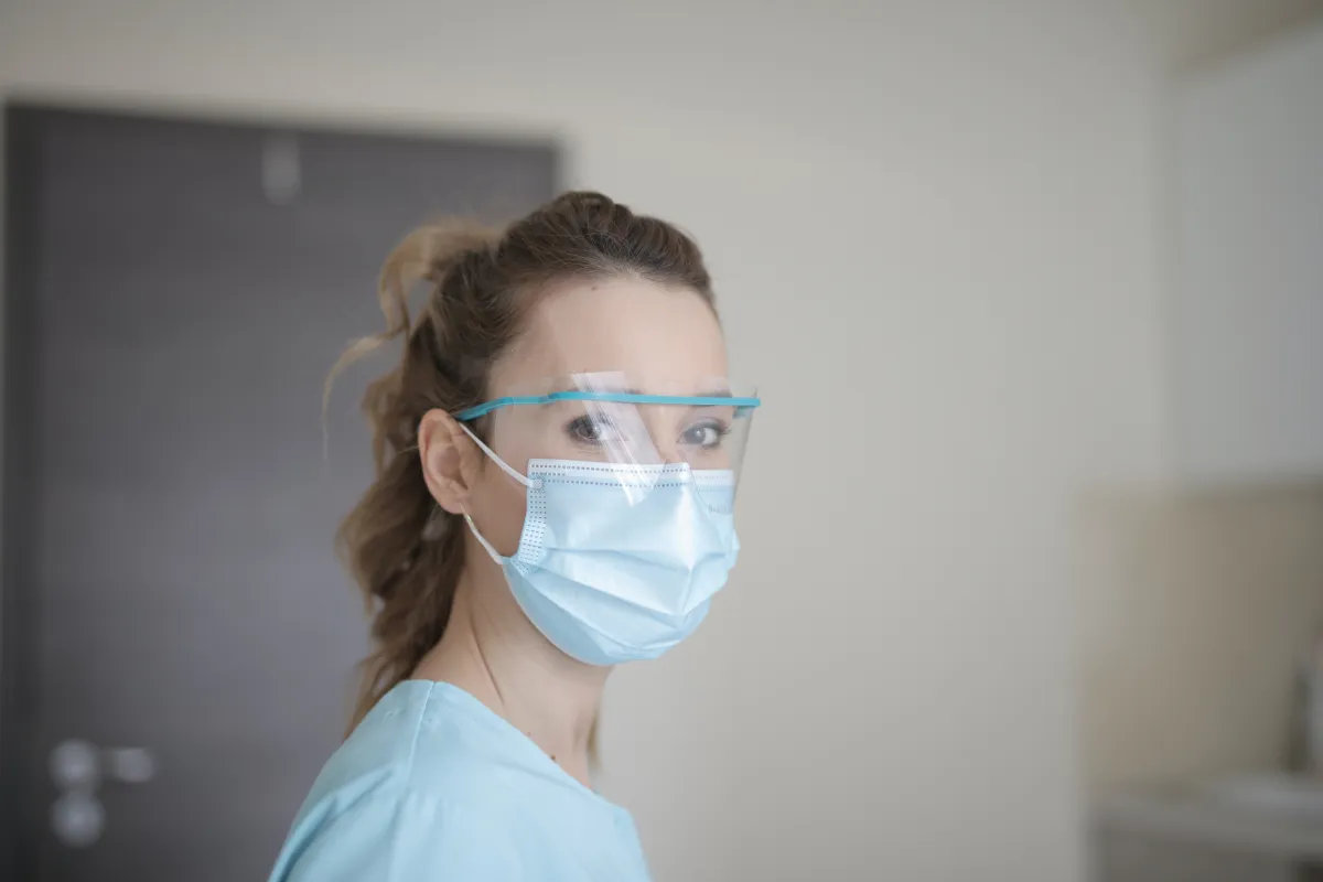 Photo of hospital worker wearing protective eye wear and face mask
