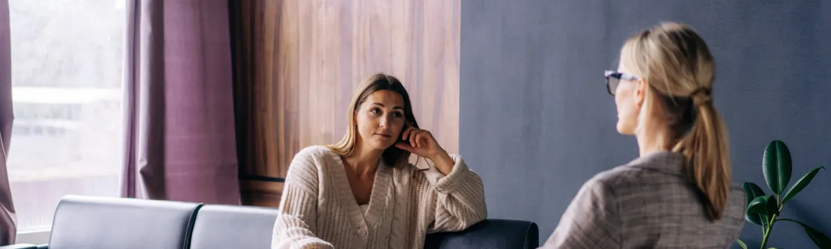 A young woman in a consultation with a professional psychologist listens to advice on improving behavior in life.