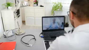 Telepsychiatry session, doctor listening to patient. Adobe Stock